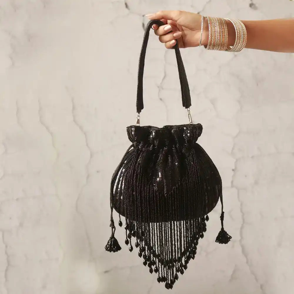 Black Twinkle Heavy Tassles Potli bag with handle by The Tan Clan, featuring decorative tassels and traditional design.