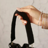 Black Twinkle Heavy Tassles Potli bag with handle by The Tan Clan, featuring intricate tassle detailing and elegant design.