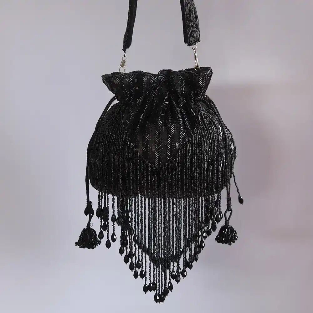 Black Twinkle Heavy Tassles Potli bag with handle from The Tan Clan, featuring intricate tassel details and a stylish design.