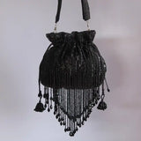 Black Twinkle Heavy Tassles Potli bag with handle from The Tan Clan, featuring intricate tassel details and a stylish design.