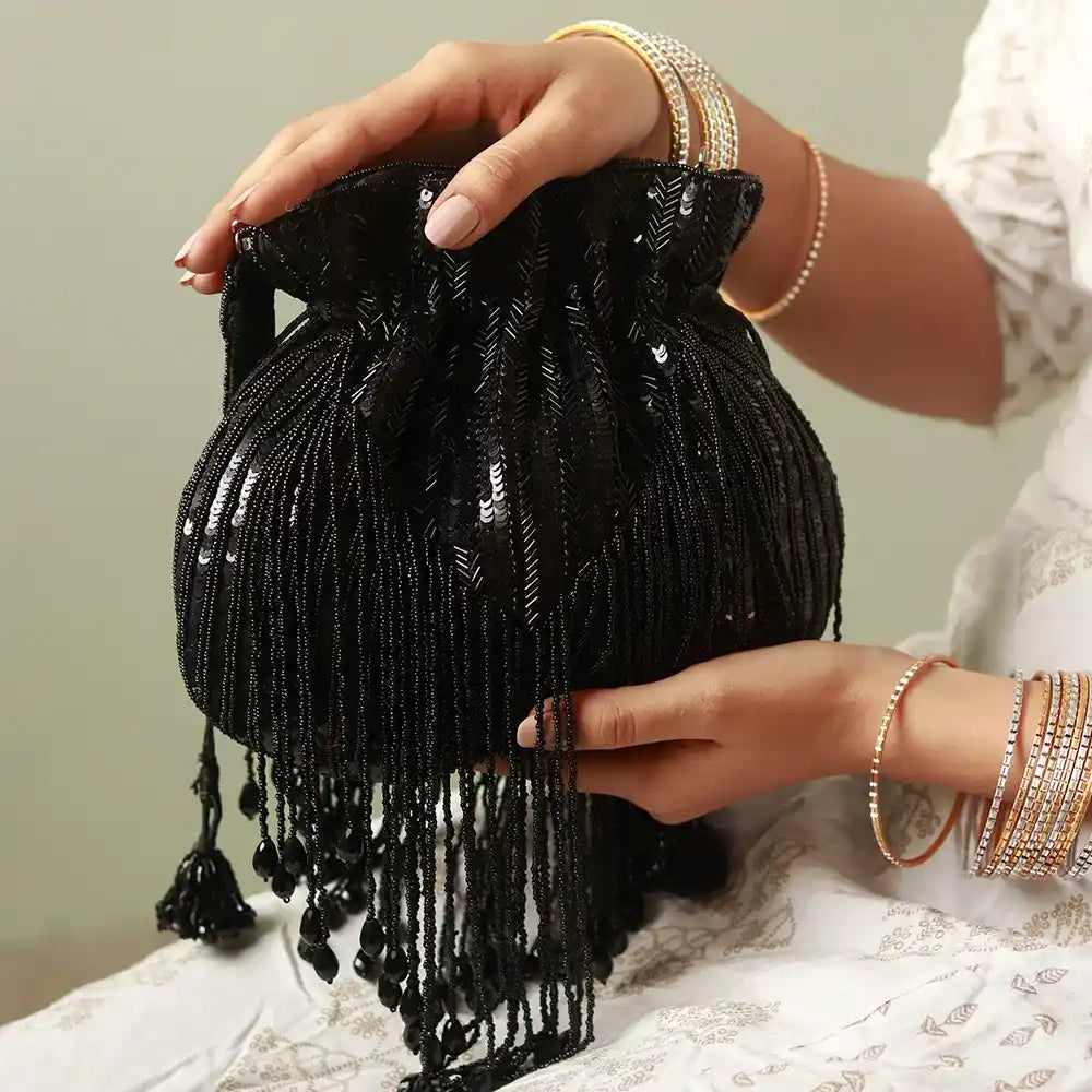 Black Twinkle Heavy Tassles Potli bag with handle by The Tan Clan, featuring intricate tassle details and elegant design.