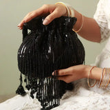 Black Twinkle Heavy Tassles Potli bag with handle by The Tan Clan, featuring intricate tassle details and elegant design.