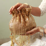 Gold Twinkle Heavy Tassles Potli bag with handle by The Tan Clan, showcasing intricate tassel details and elegant design.