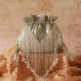 Silver Twinkle Heavy Tassles Potli bag with handle by The Tan Clan, featuring intricate tassel details and elegant design.