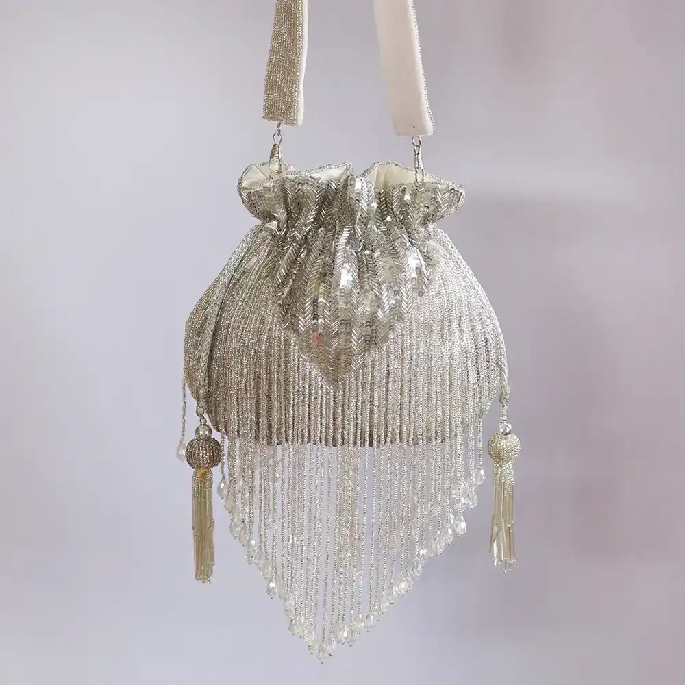 Silver Twinkle Heavy Tassles Potli bag with handle by The Tan Clan, featuring intricate tassel details and elegant design.