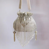 Silver Twinkle Heavy Tassles Potli bag with handle by The Tan Clan, featuring intricate tassel details and elegant design.
