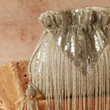 Silver Twinkle Heavy Tassles Potli bag with handle from The Tan Clan, featuring intricate tassel details and a sleek design.