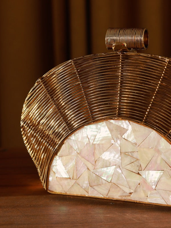 Mother of pearl clutch by The Tan Clan featuring a sleek, elegant design with a shiny, iridescent surface and compact shape.