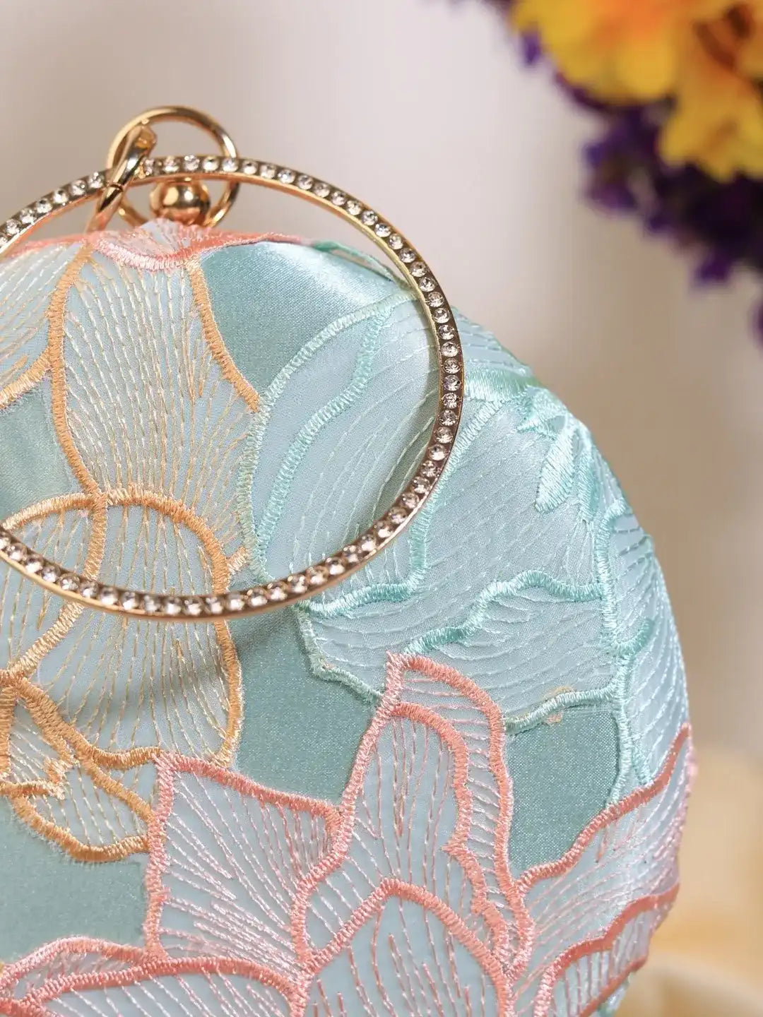 Tide Blue round clutch bag by The Tan Clan featuring a sleek, circular design with a smooth finish and stylish appearance.