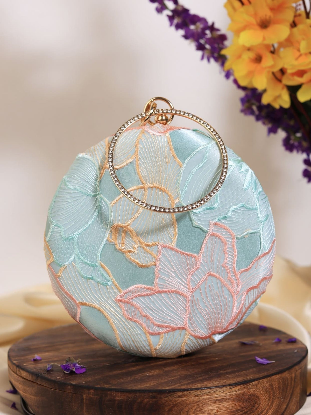 Tide Blue Round Clutch by The Tan Clan featuring a smooth round design and vibrant blue color, perfect for stylish accessories.
