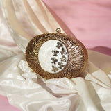 Elegant Titly Wirework clutch by The Tan Clan featuring intricate wire design and mother of pearl accents.