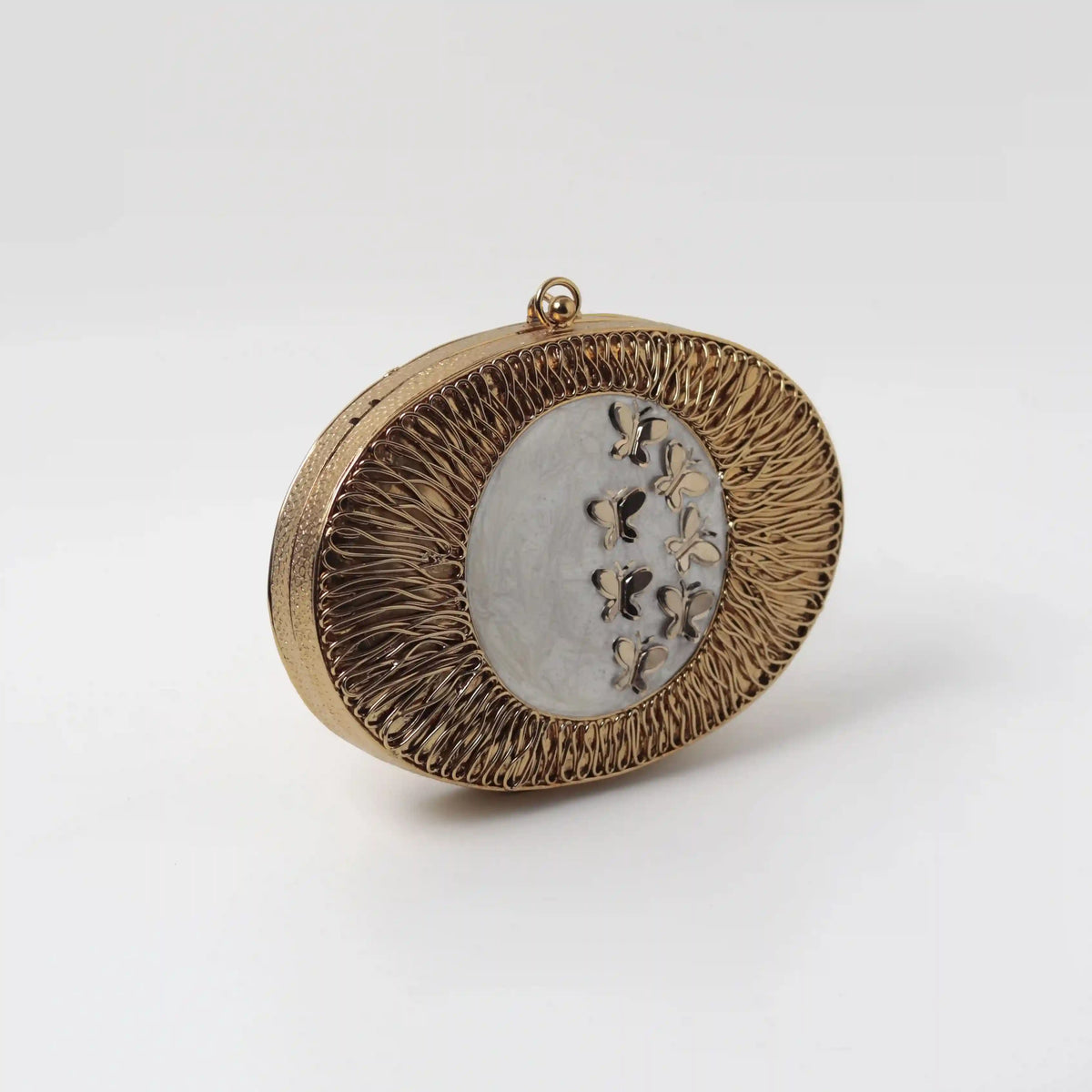 Titly wirework clutch by The Tan Clan featuring mother of pearl details and intricate handcrafted design.