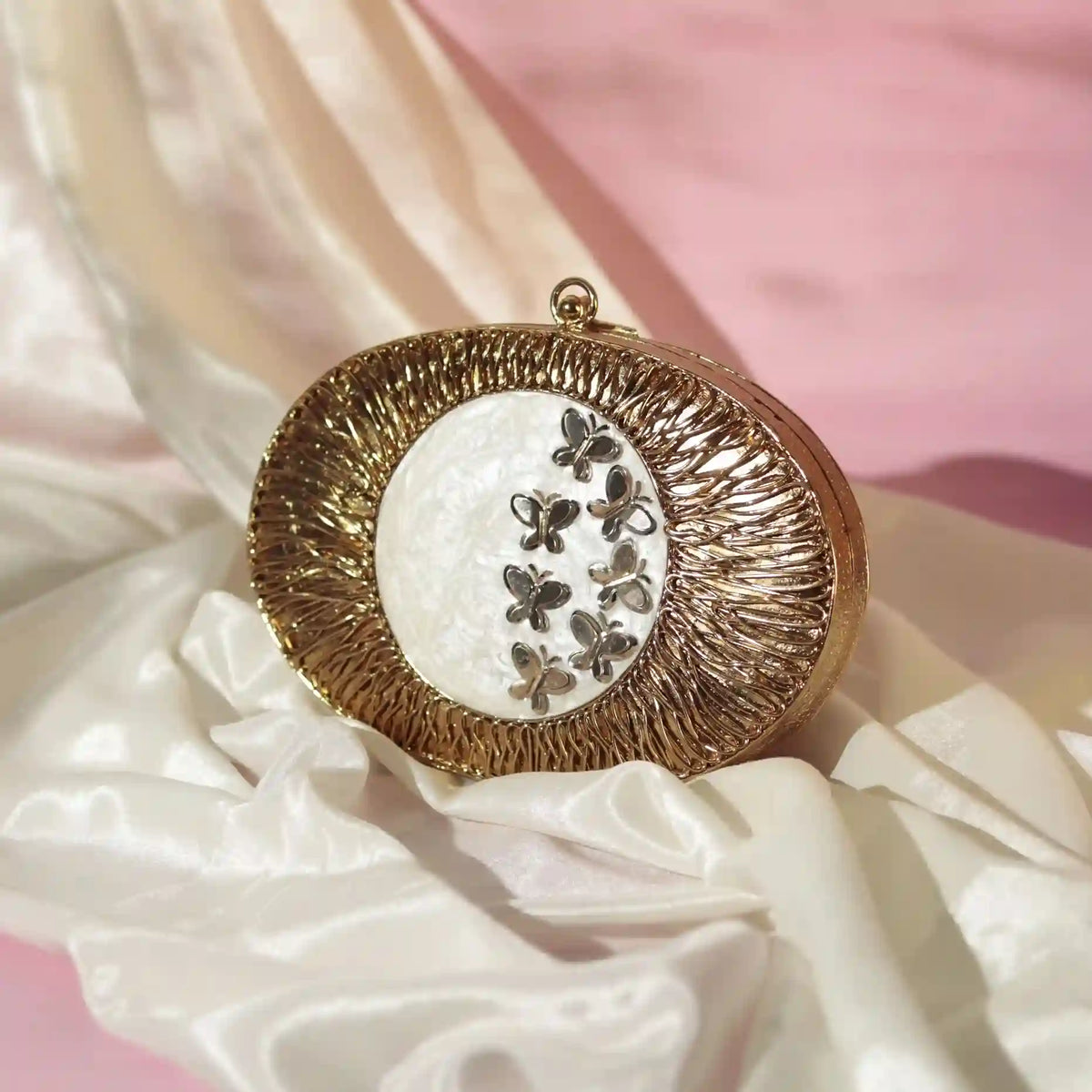 Elegant Titly wirework clutch by The Tan Clan featuring mother of pearl accents and intricate craftsmanship.