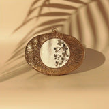 Titly wirework clutch by The Tan Clan featuring intricate wire design and elegant mother of pearl accents.