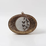Titly wirework clutch by The Tan Clan featuring intricate wire design with mother of pearl accents.