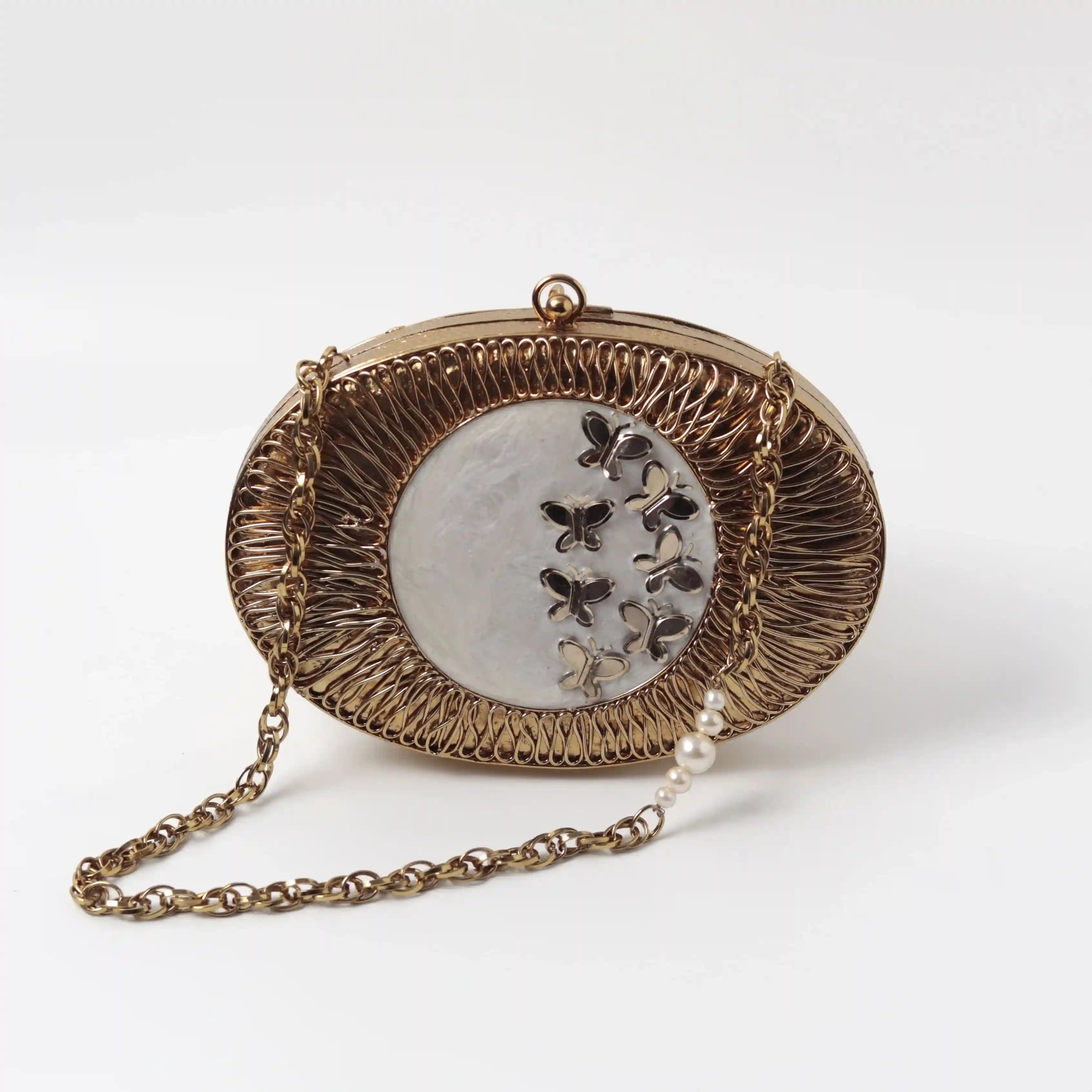 Elegant Titly wirework clutch by The Tan Clan featuring intricate mother of pearl details and a sleek, stylish design.