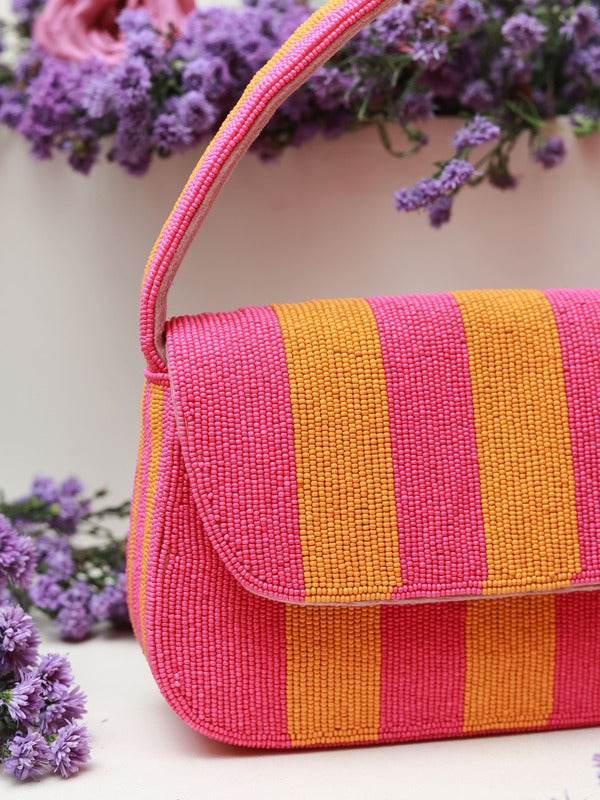 Orange and pink Tulip Baguette Bag with handle by The Tan Clan, showcasing its vibrant color and sleek design.
