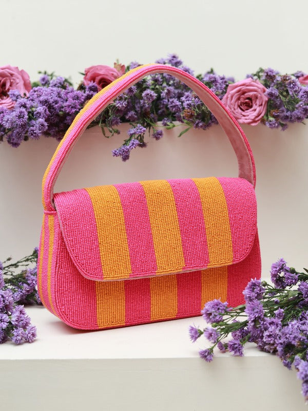 Orange and pink Tulip Baguette Bag with handle by The Tan Clan, featuring a stylish, compact design and vibrant color accents.