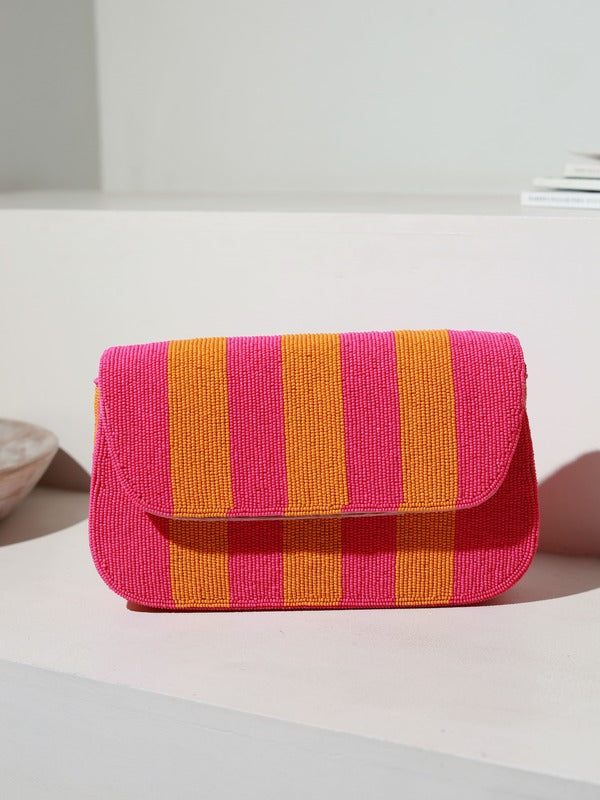 Orange and pink Tulip Baguette Bag with handle by The Tan Clan, showcasing its stylish design and compact size.
