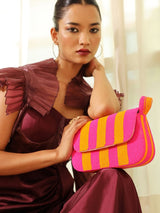 Orange and pink Tulip Baguette Bag with handle from The Tan Clan, featuring a stylish, compact design and textured material.