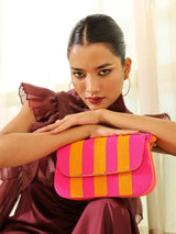 Orange and pink Tulip Baguette Bag with handle by The Tan Clan, featuring a vibrant floral design and compact, stylish shape.