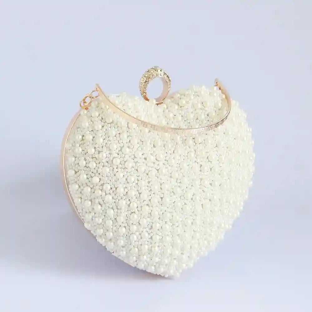 Ulfat All White Pearl Hand Embroidered Heart Clutch by The Tan Clan, featuring intricate pearl embroidery and a heart-shaped design.