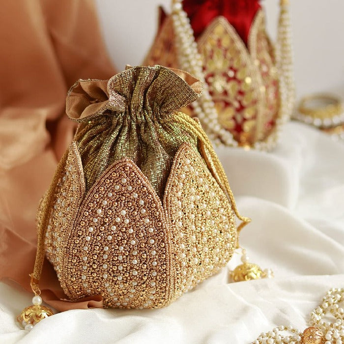 Hand-embroidered Uttara mini lotus potli bag by The Tan Clan with intricate embroidery and a drawstring closure.