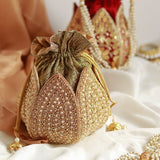 Hand-embroidered Uttara mini lotus potli bag by The Tan Clan with intricate embroidery and a drawstring closure.