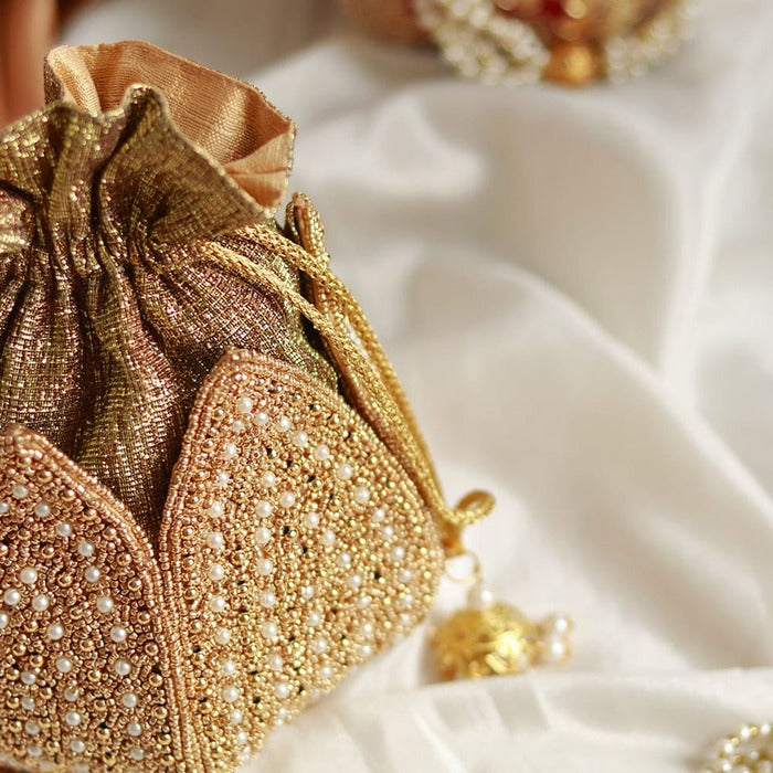 Hand-embroidered mini lotus potli bag from The Tan Clan featuring intricate embroidery and traditional design.