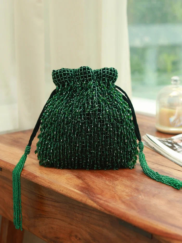 Rosa green Potli bag with handle by The Tan Clan, featuring traditional embroidery and a drawstring closure.