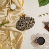 Black Zafraan clutch bag by The Tan Clan featuring intricate hand embroidery and a sleek, elegant design.