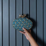 Blue Zafraan hand-embroidered clutch bag by The Tan Clan, featuring intricate embroidery and a sleek design.