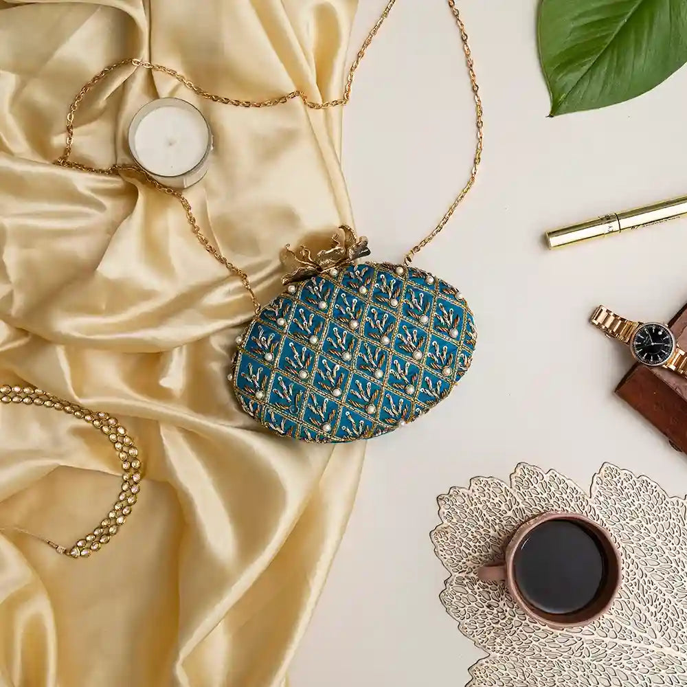 Blue Zafraan hand-embroidered clutch purse by The Tan Clan with intricate embroidery and compact design.