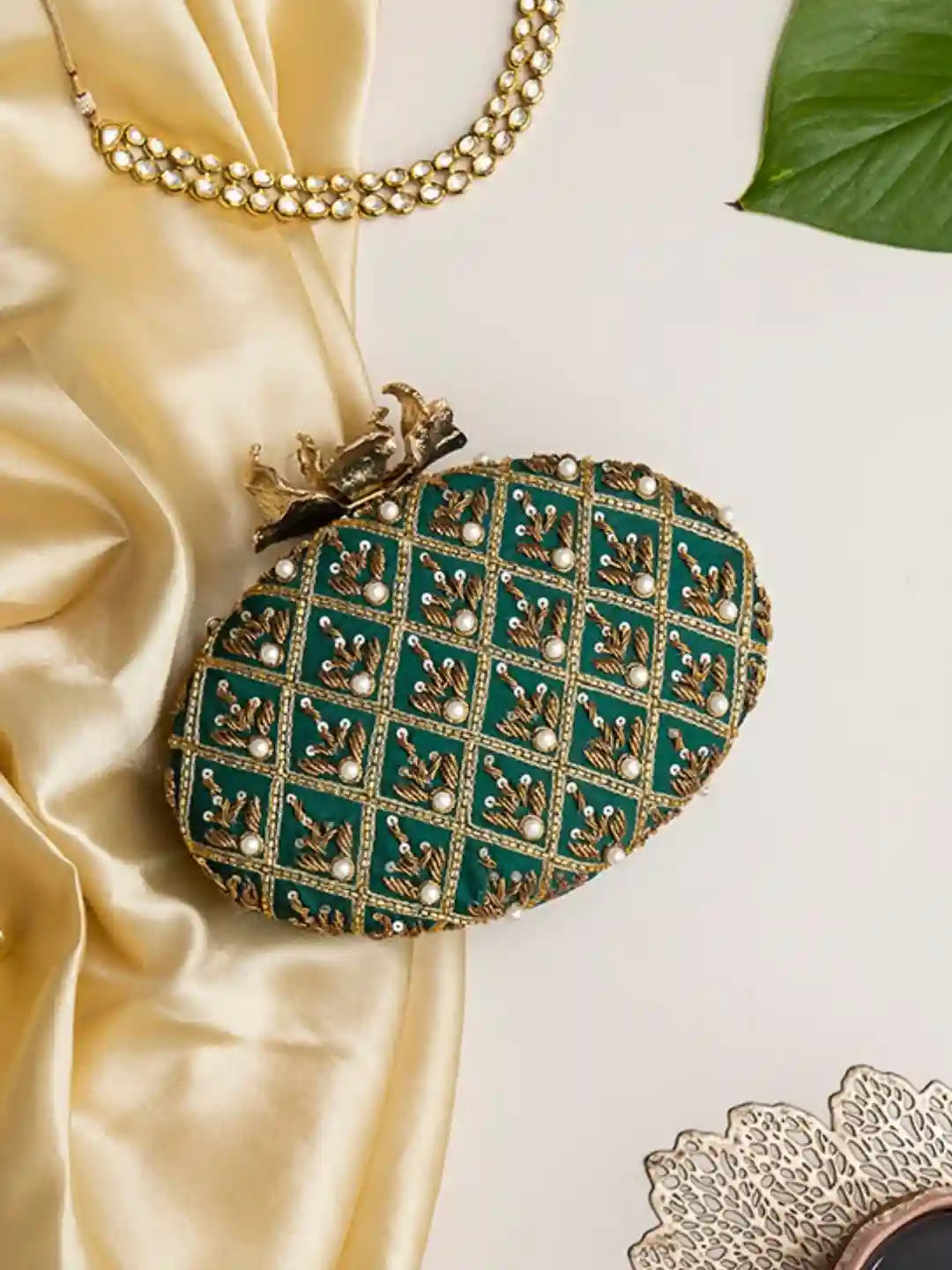 Hand-embroidered Zafraan clutch bag by The Tan Clan featuring intricate embroidery and a stylish design.