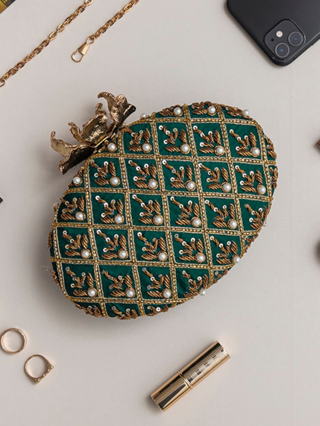 Green Zafraan hand-embroidered clutch bag by The Tan Clan with intricate embroidery and elegant design.