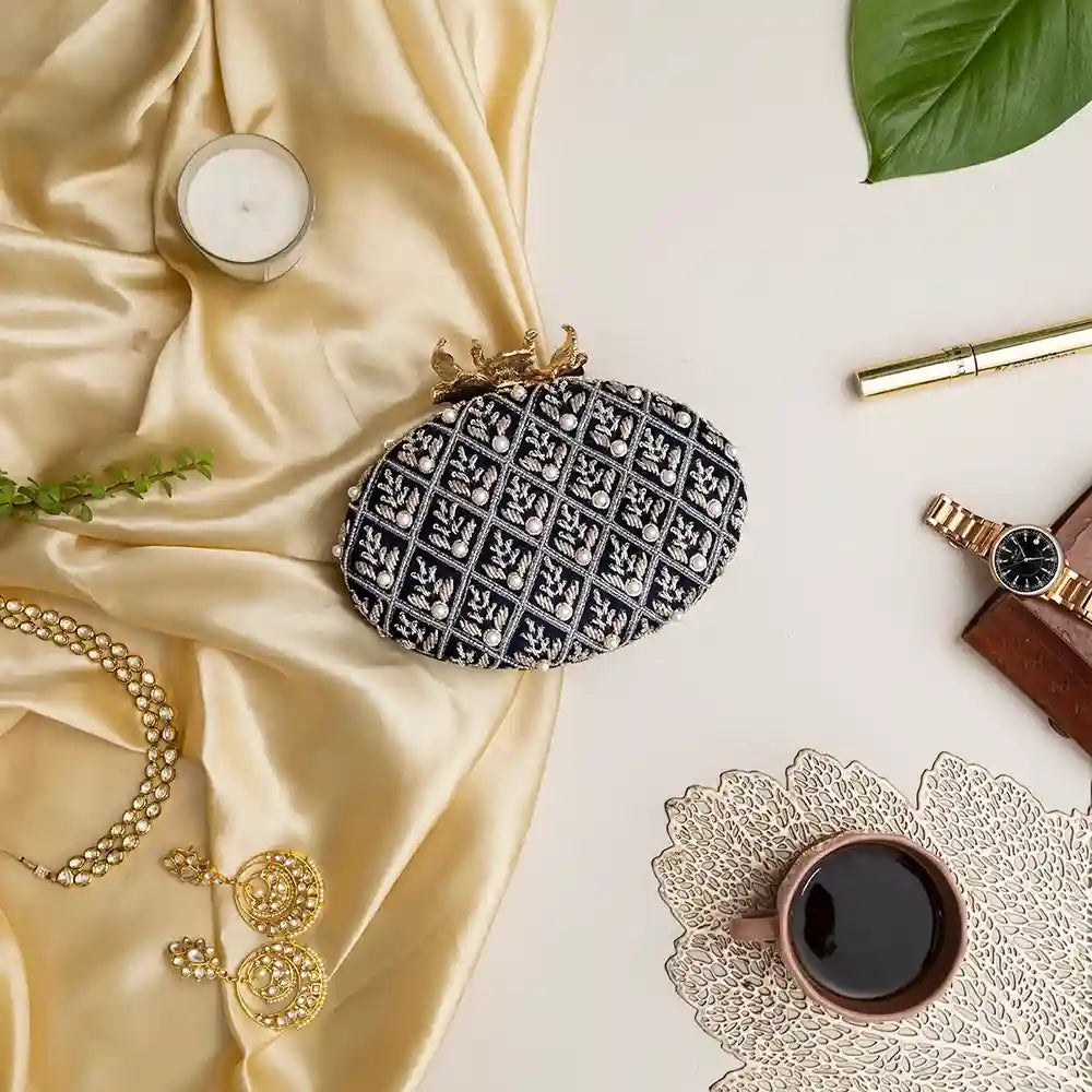 Navy blue Zafraan hand-embroidered clutch by The Tan Clan with intricate embroidery and elegant design.