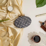 Navy blue Zafraan hand-embroidered clutch by The Tan Clan with intricate embroidery and elegant design.