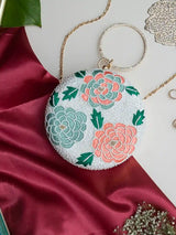 Round floral embroidered clutch bag from The Tan Clan with intricate hand embroidery and vibrant floral patterns.