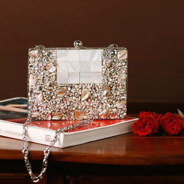 Zoya Embellished Brass Clutch by The Tan Clan featuring intricate embellishments and a sleek design for elegant occasions.