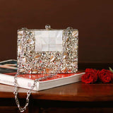 Zoya Embellished Brass Clutch by The Tan Clan featuring intricate embellishments and a sleek design for elegant occasions.