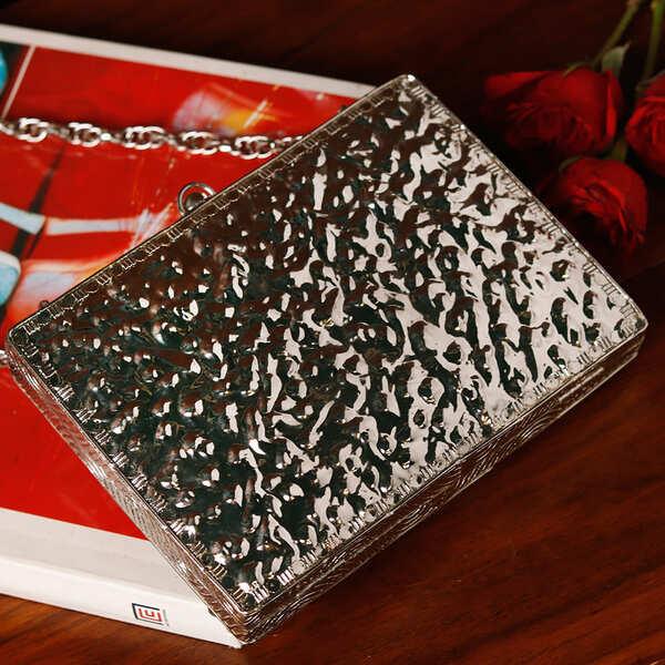 Zoya embellished brass clutch with intricate designs, featuring a compact rectangular shape and decorative detailing.