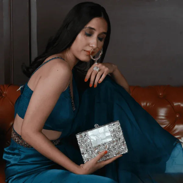 Zoya Embellished Brass Clutch by The Tan Clan featuring intricate embellishments and a sleek, elegant design.