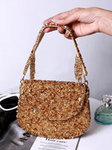 Amy Gold Flap Over Bag from The Tan Clan, a stylish leather flap bag with a gold finish and adjustable strap, on a plain background.