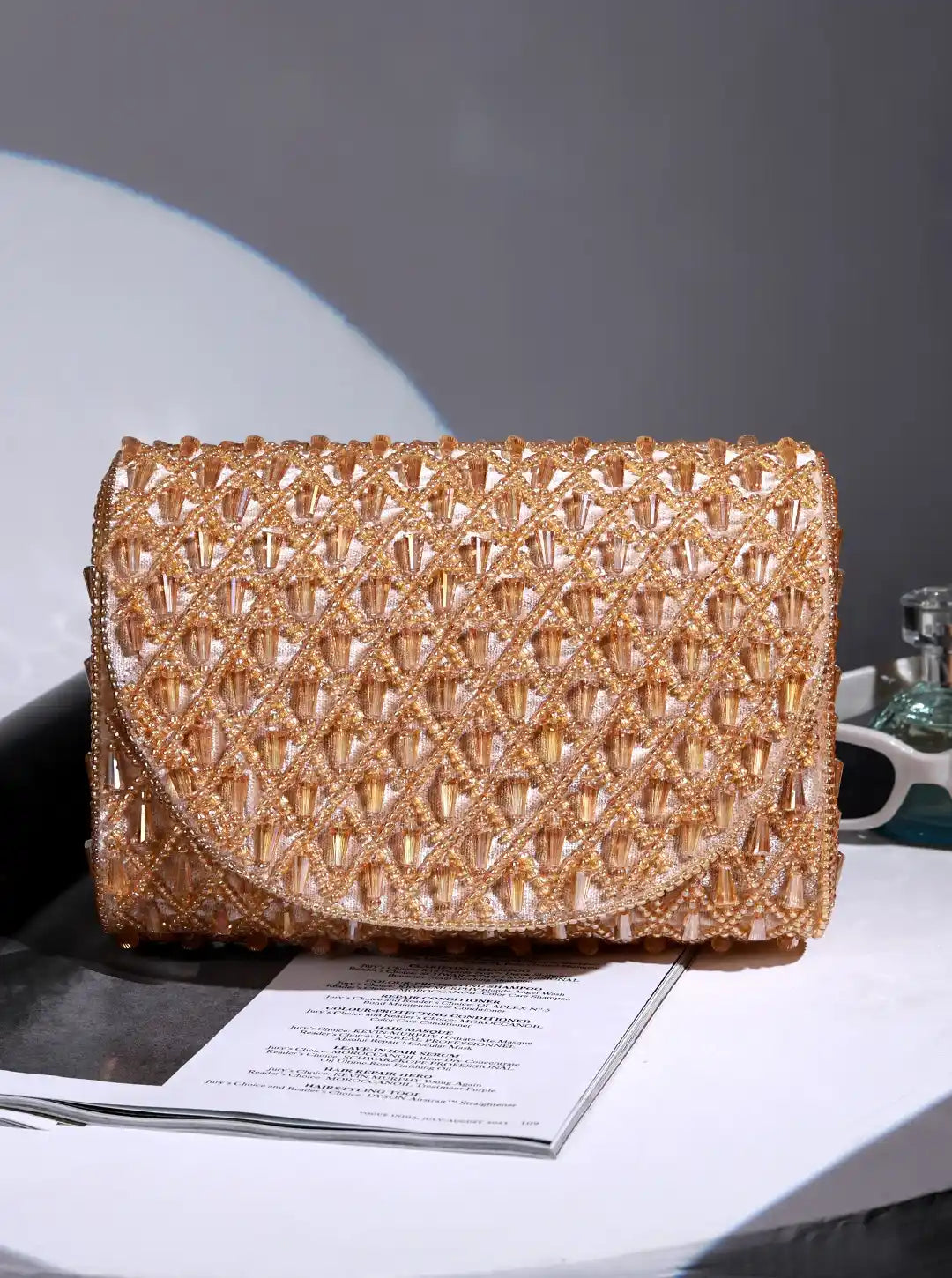Gold flap-over bag from The Tan Clan's Claire collection, stylish leather handbag with a sleek design and top flap closure.