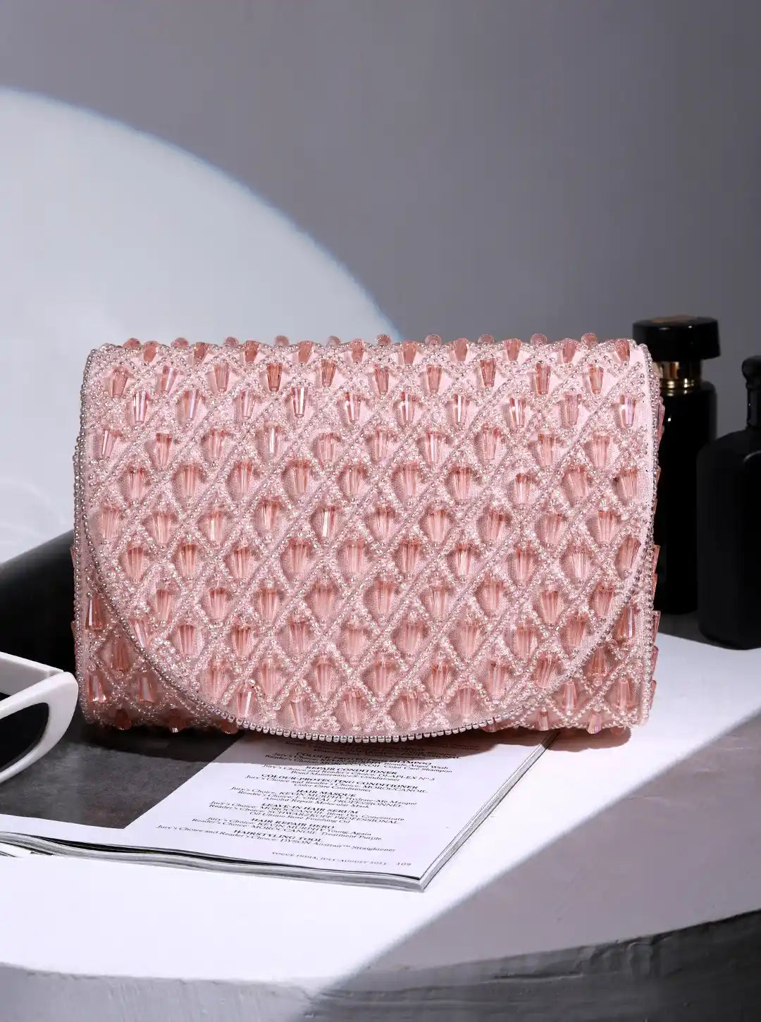 Pink flap-over bag from The Tan Clan's Claire collection, featuring a stylish design with a flap closure and adjustable strap.