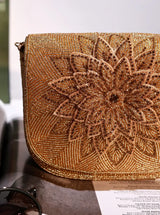 Eva Gold Flap Over Bag by The Tan Clan featuring a stylish gold flap, leather shoulder strap, and spacious interior for everyday use.