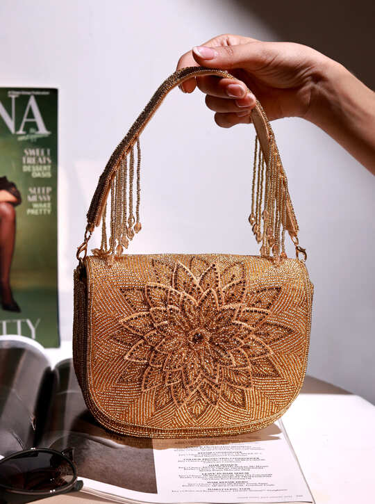Eva Gold Flap Over Bag from The Tan Clan, stylish flap bag with gold accents, featuring a sleek design and spacious interior.
