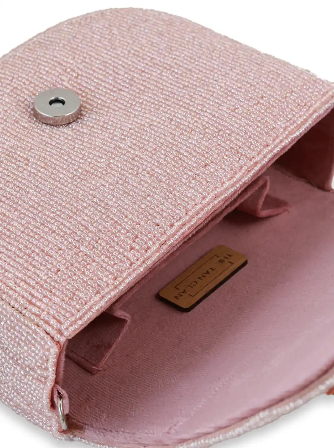 Eva pink flap-over bag by The Tan Clan featuring a stylish design with a top flap closure and shoulder strap.