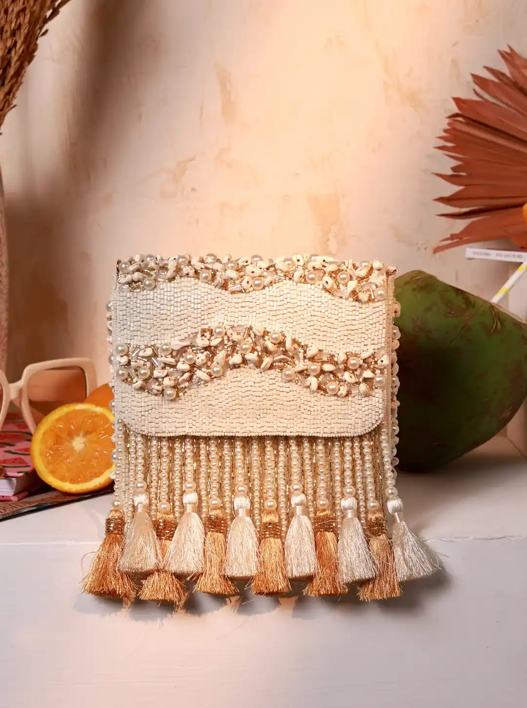 The Tan Clan Jena embellished flap-over bag featuring a stylish design with decorative details and a secure flap closure.