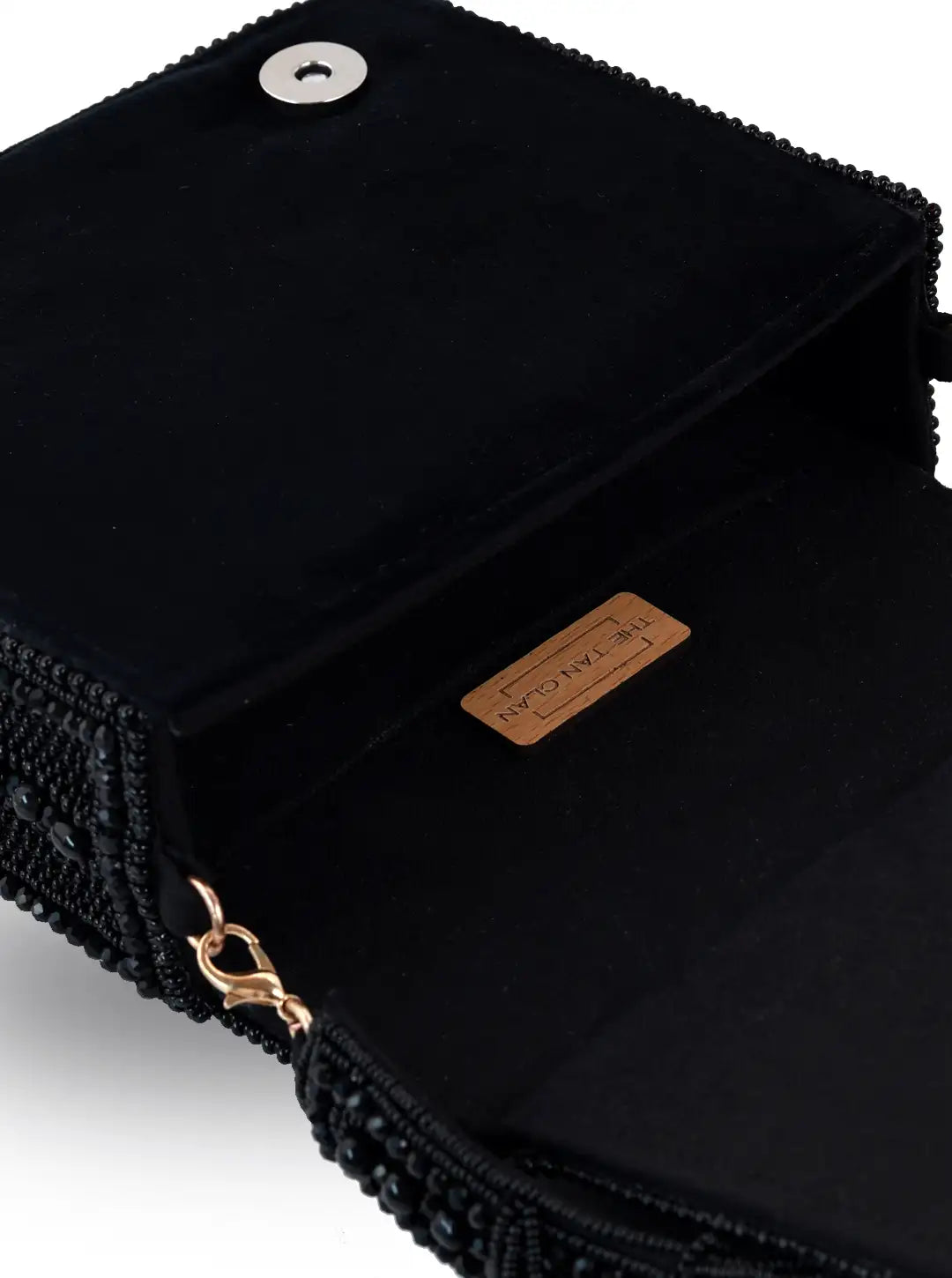 Black Megan flap-over bag by The Tan Clan, stylish leather shoulder bag with a flap closure and adjustable strap.